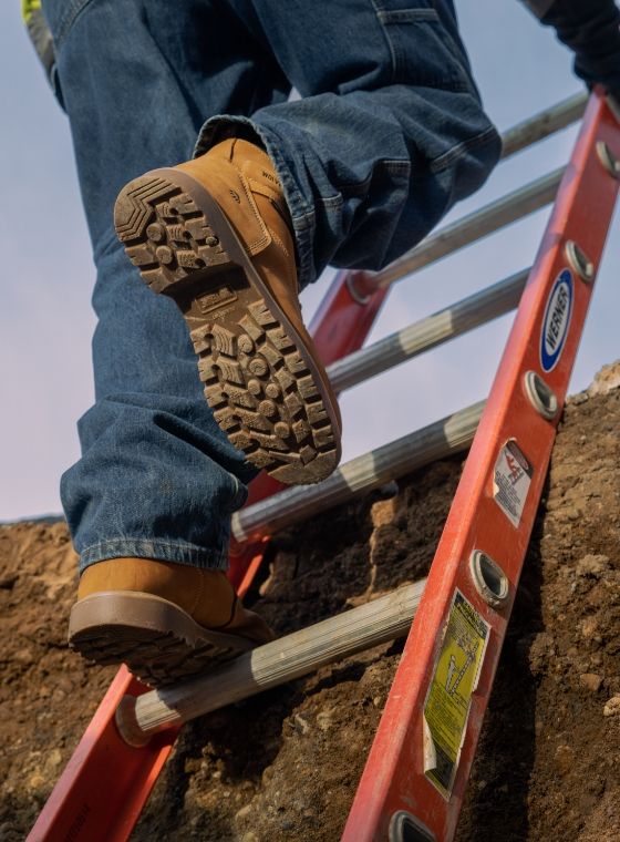 a person walking up a ladder